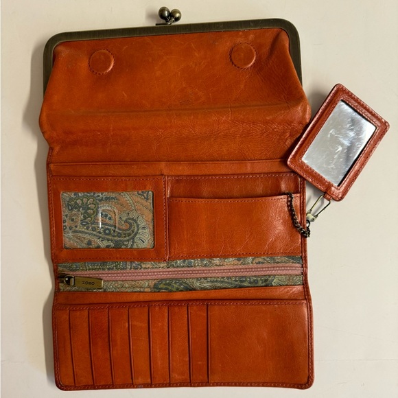 HOBO Handbags - Vtg. Hobo orange billfold leather wallet with kiss and magnetic closures.